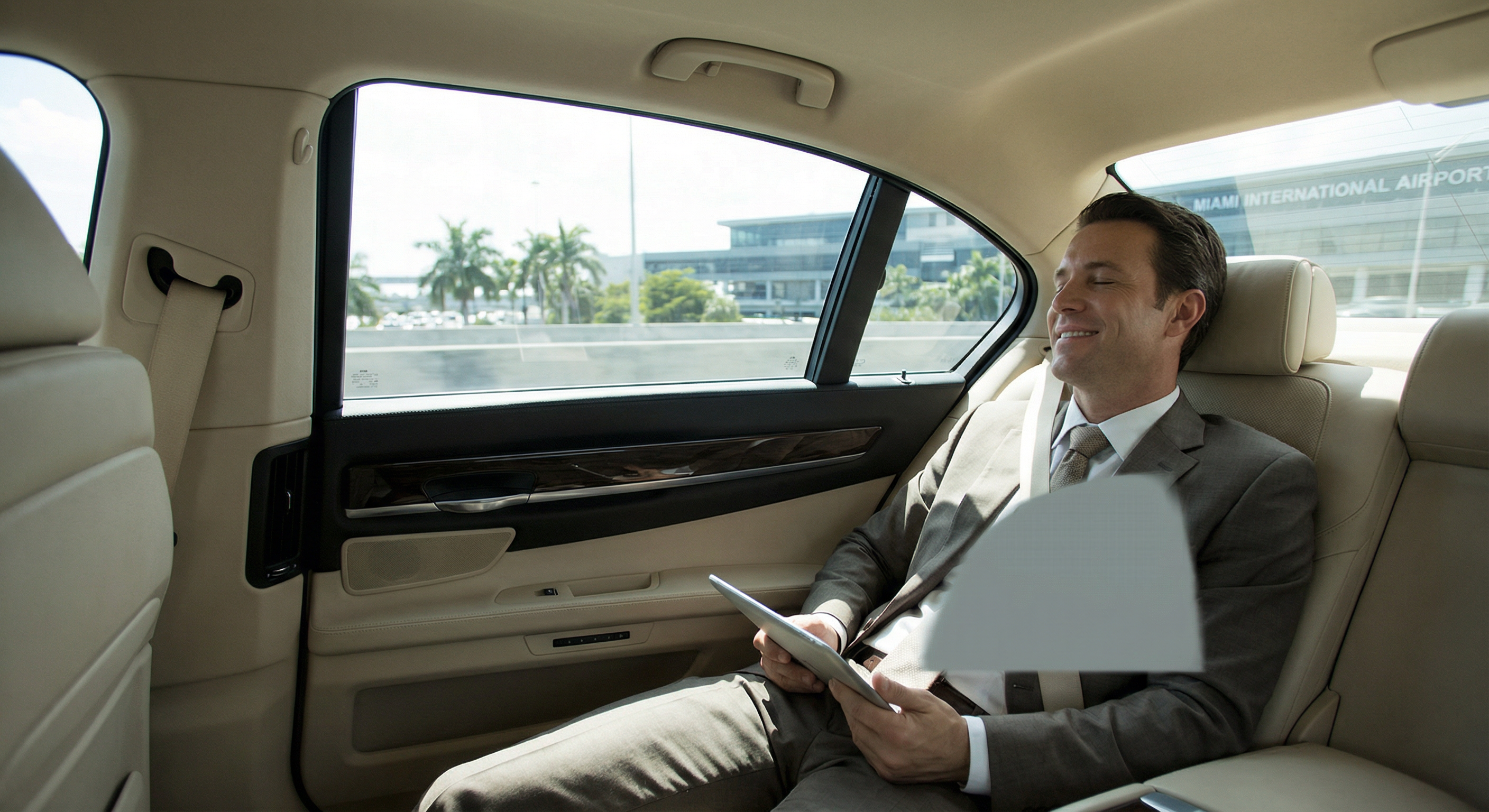 Traveler in luxury sedan for Miami airport transportation