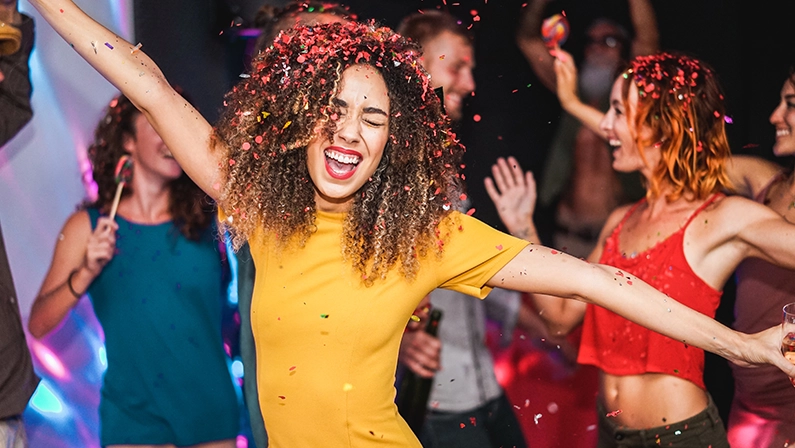 Young friends dancing at home private party - Happy people having fun listening music and drinking champagne at night - Alternative fest during Coronavirus time - Focus on afro hair girl face